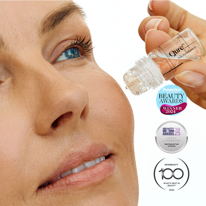 Close-up of a woman's face with a bottle of micro infusion product, featuring Qure awards on a white background.