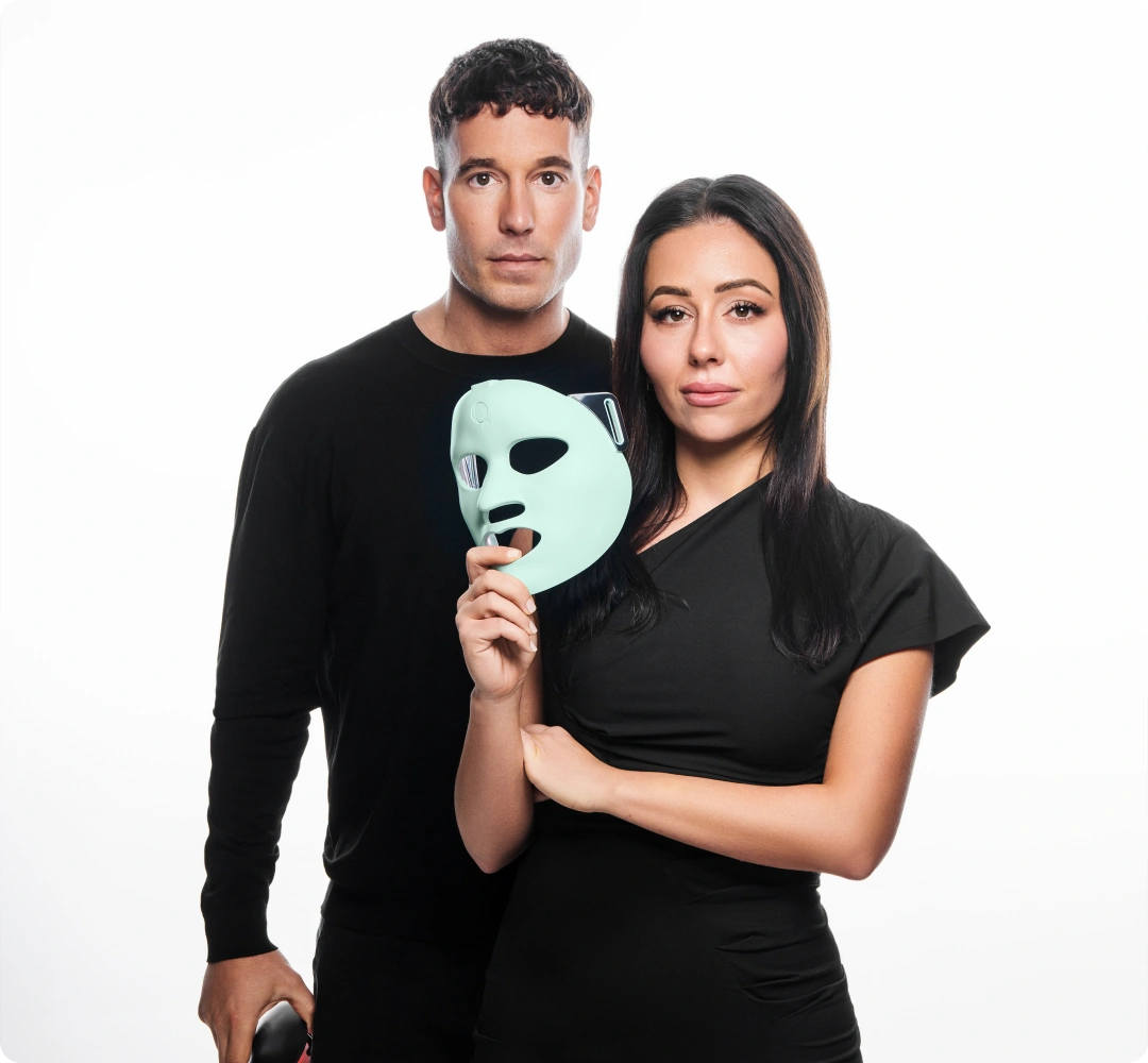 Man and woman with LED face mask.